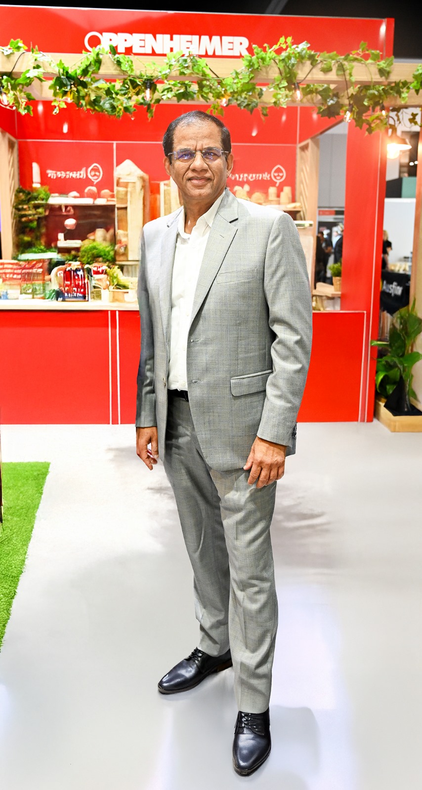 Portrait of Jignesh Shah standing at an Oppenheimer trade show booth